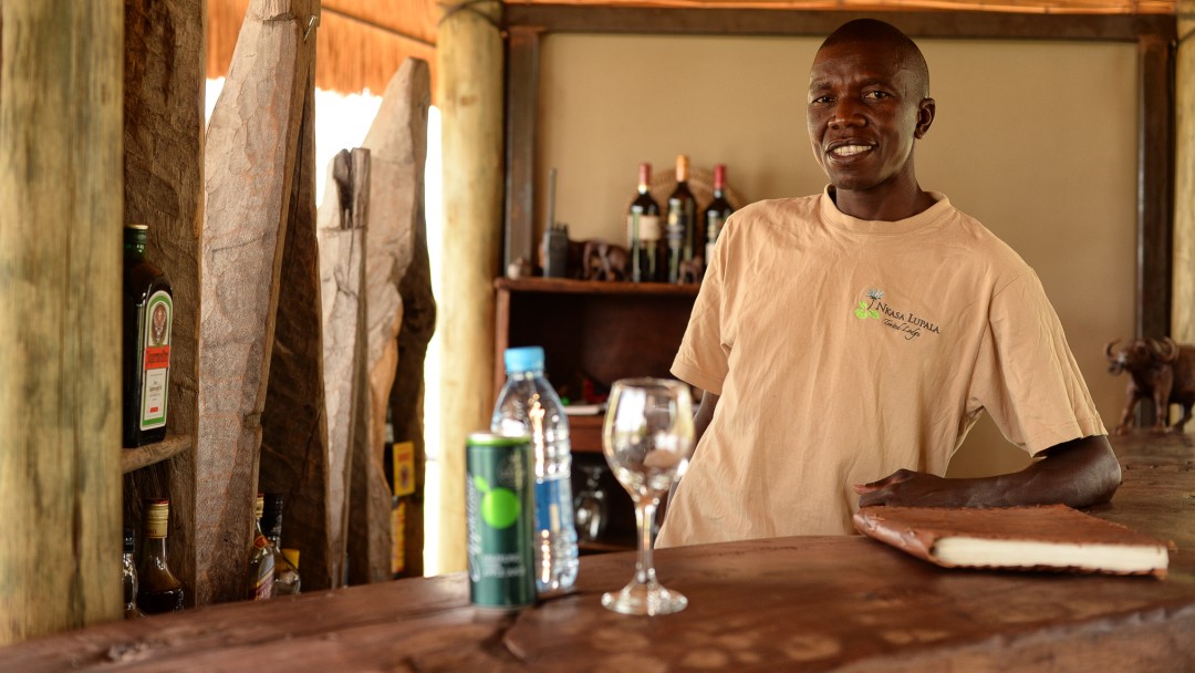 A man servinng drinks in a local bar