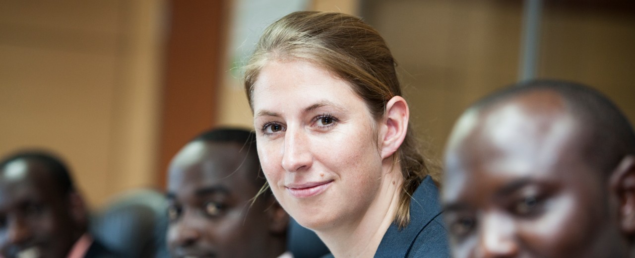 A woman sitting at an konference table with africans