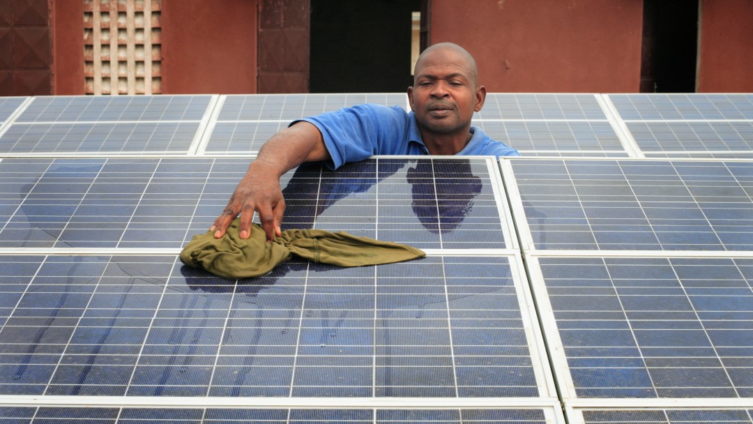 A man is cleaning a solar system