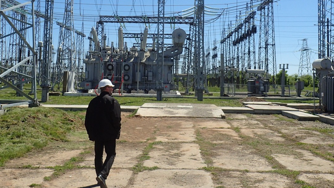 Man in front of power grid