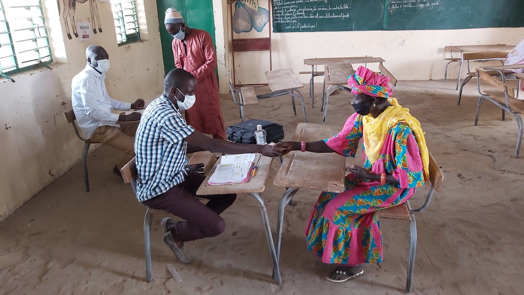 Two people sitting in an old classroom 