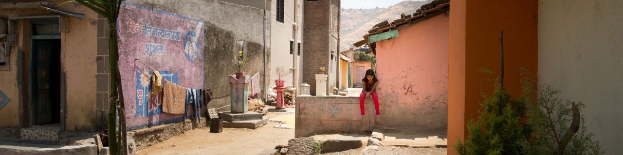 Girl sitting in empty neighbourhood in India