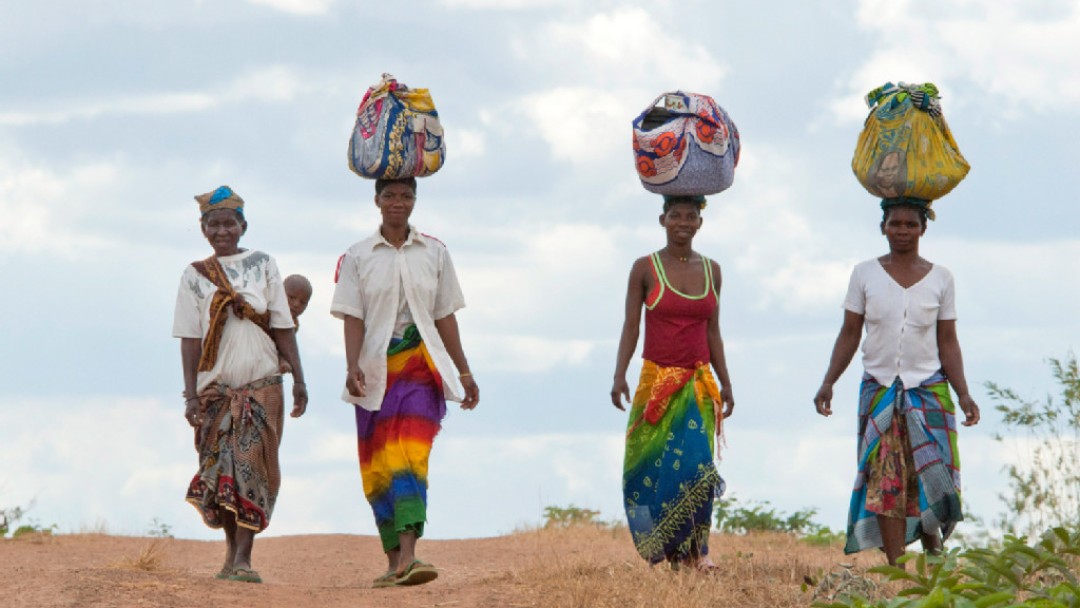  Women with products on their heads on their way to a market.