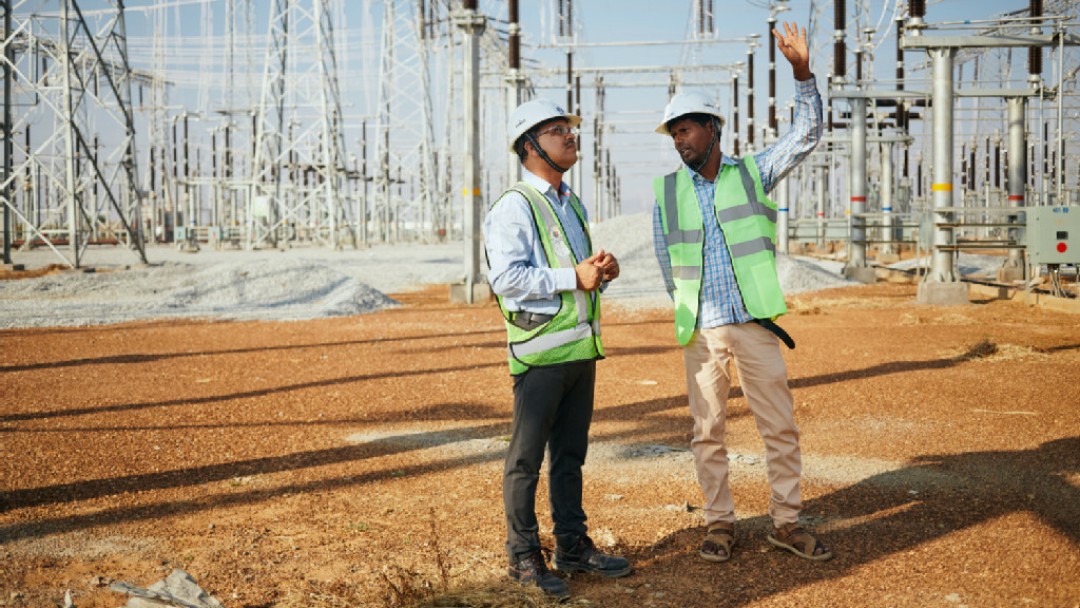 Two men on the site of a transformer station