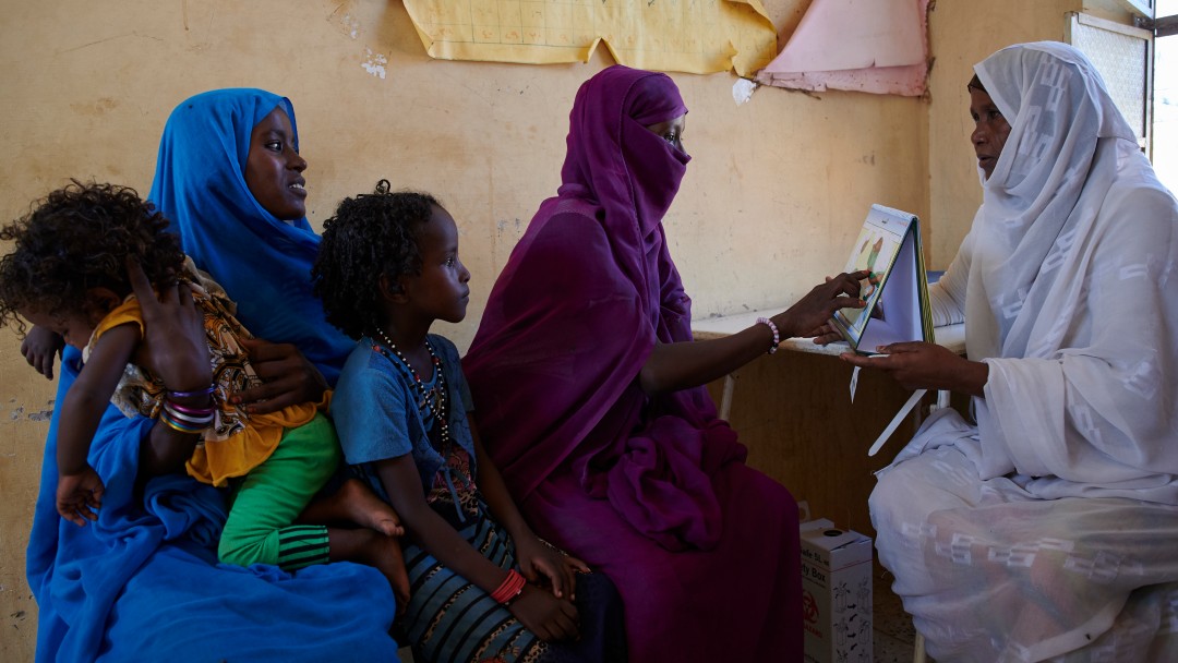 Women sitting and talking in health centre,