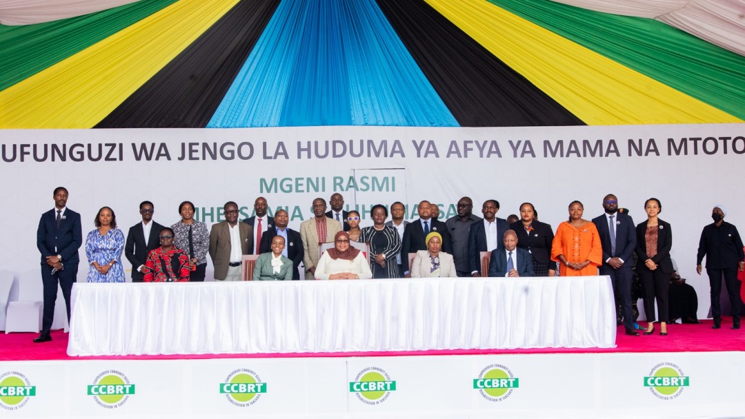 Several people standing on a stage behind a table