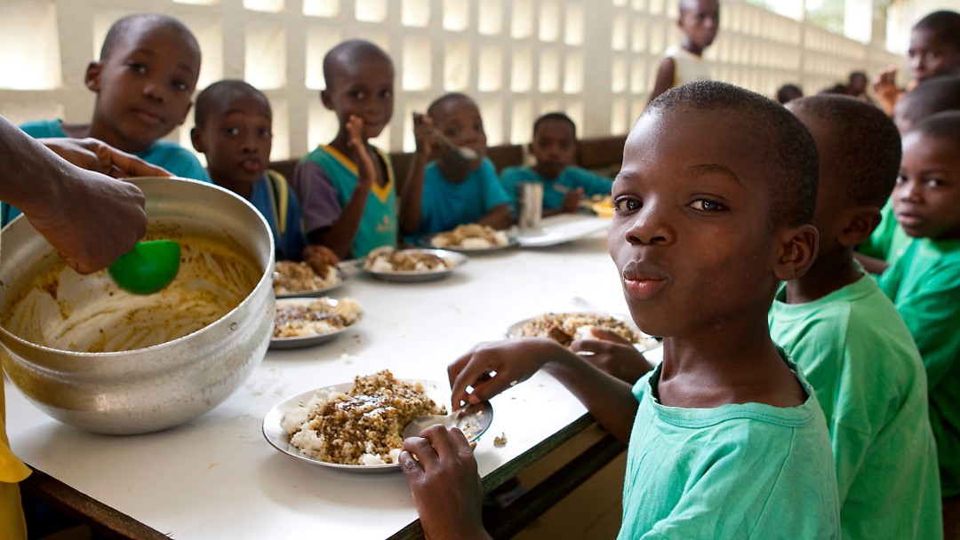 Children sit at the table and eat 