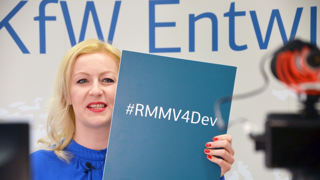 A woman holds a blue folder