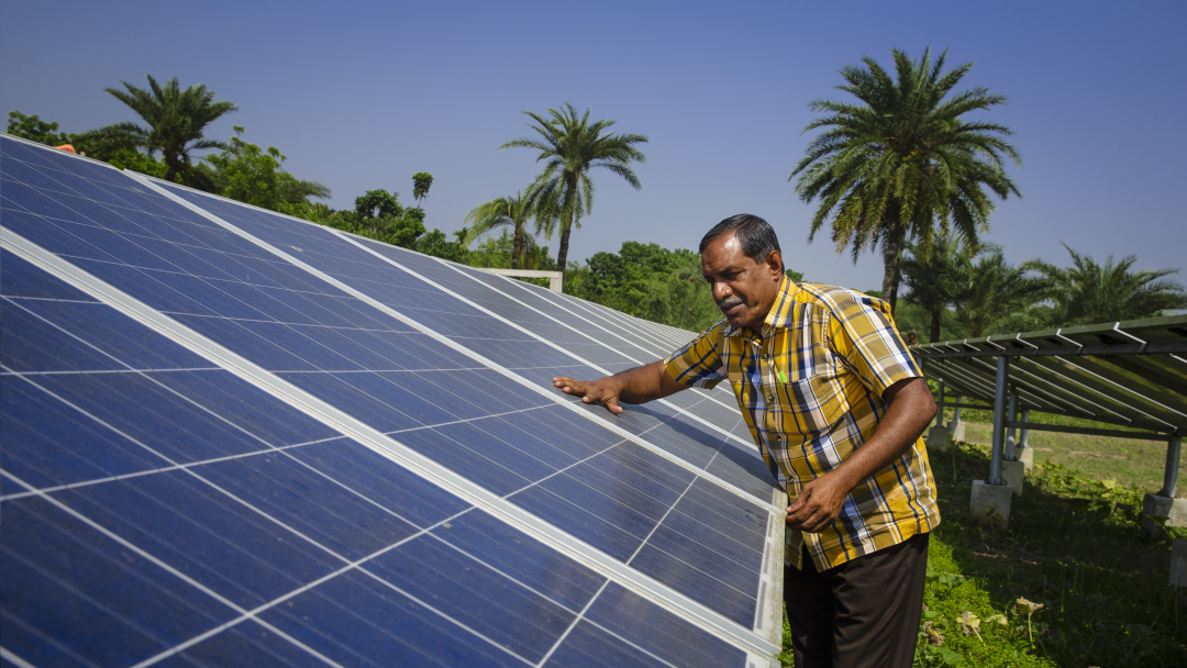 Man fixes a solar panel
