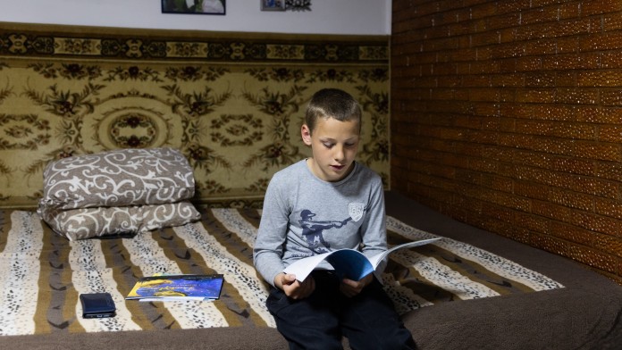 Boy reading on a bed
