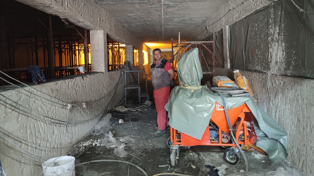 Construction site inside a building with covered machinery