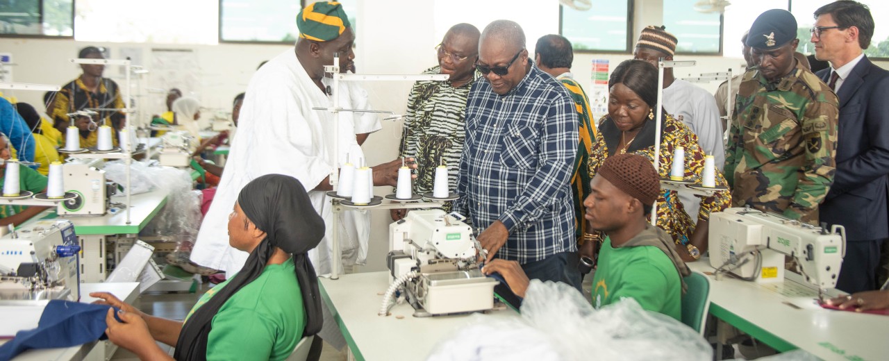 The President of Ghana, the German Ambassador and other guests are taking a tour of the production facility
