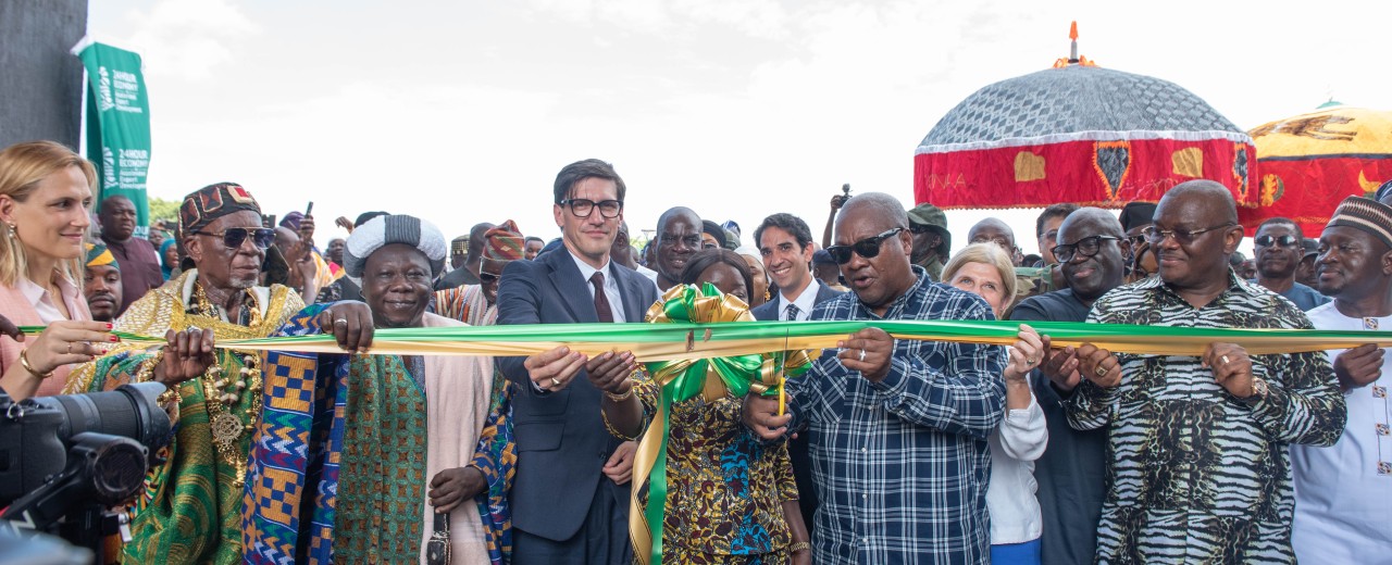 A group of people, including the President of Ghana and the German Ambassador, cut the ribbon to mark the opening of the textile factory