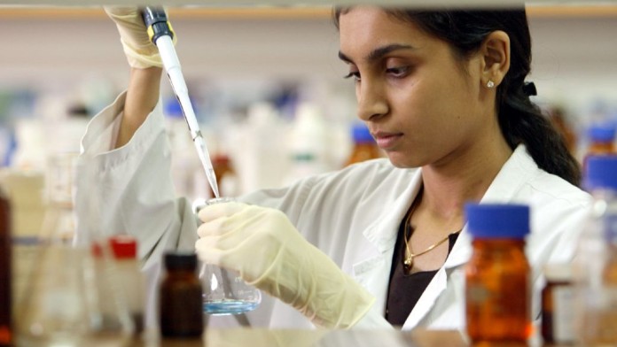 Woman working in a laboratory with a pipette