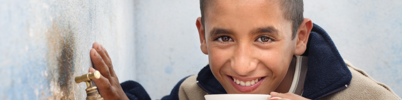 Boy drinking from a cup