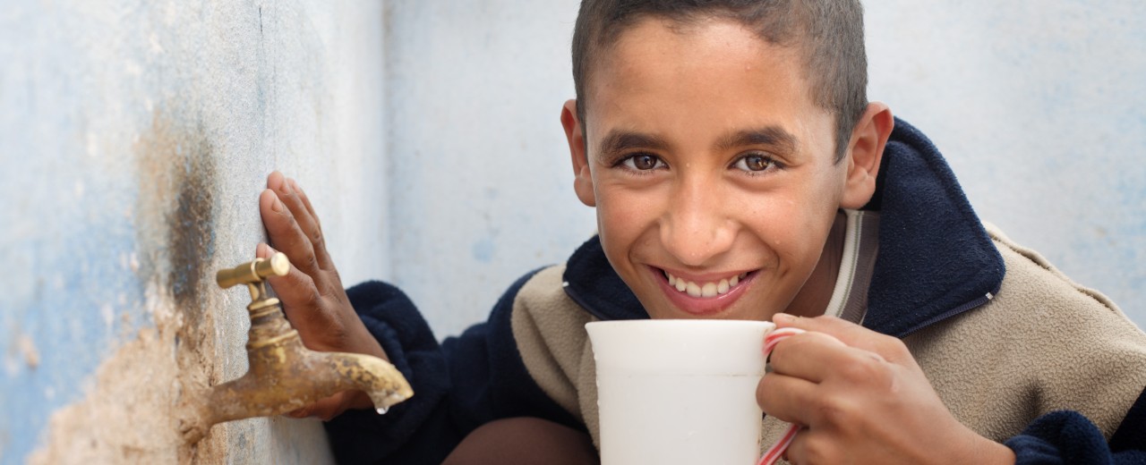 Boy drinking from a cup