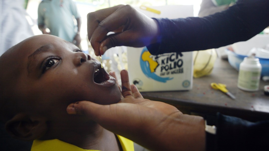 Nigerian boy receives an oral polio vaccination.