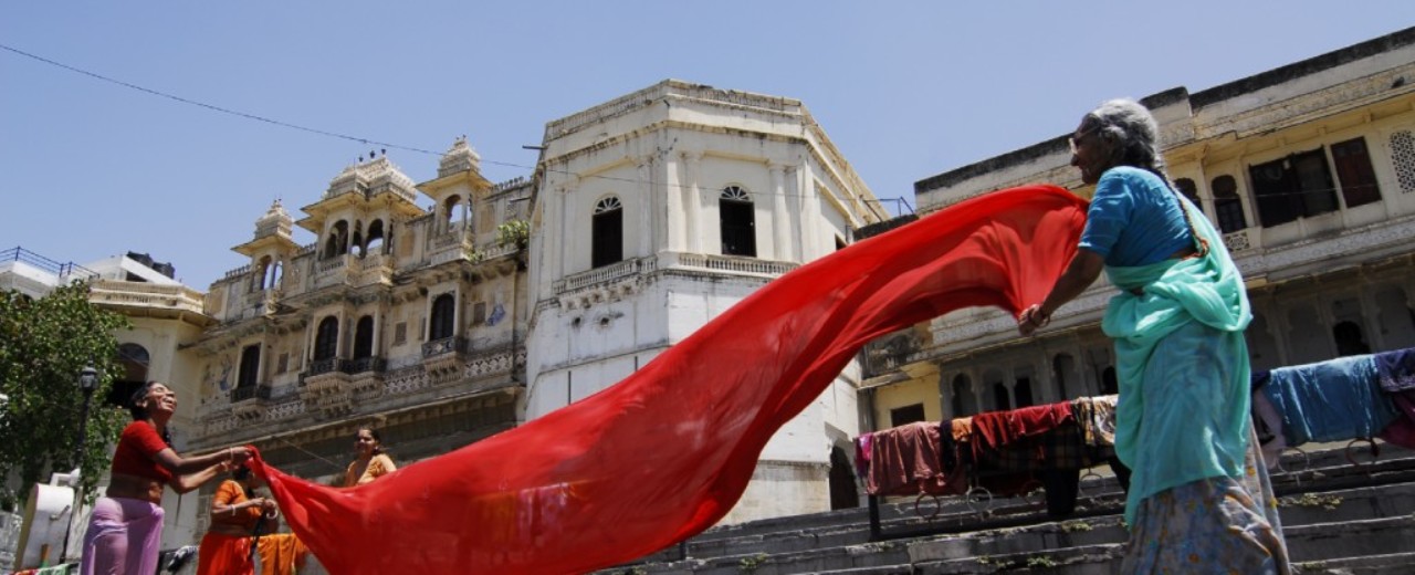 India- women folding red scarfs