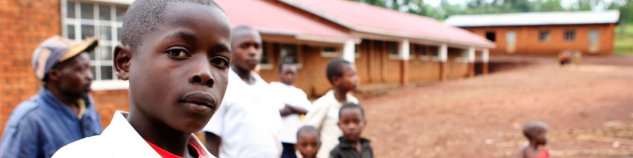 Pupil in front of their school