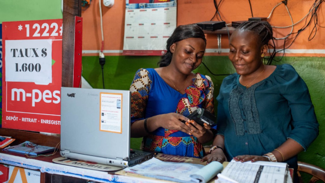 Two women with an electronic billing device