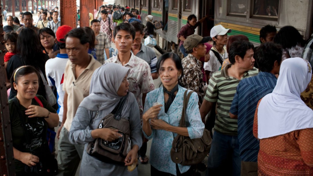 Central station in a large city, passengers boarding a train