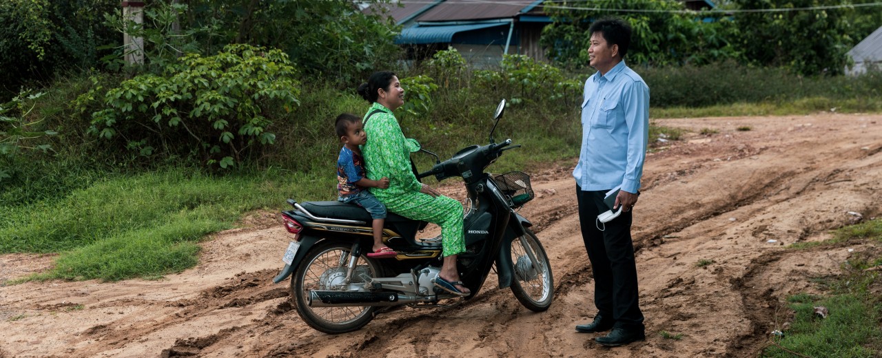 A woman with child on a roll, A man standing opposite
