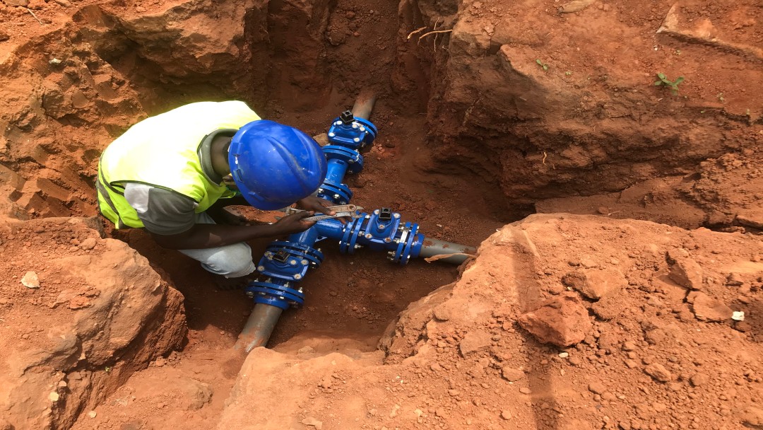 Construction worker laying pipes 