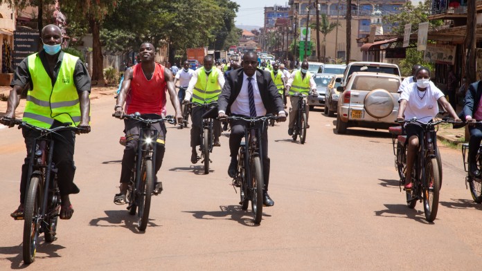 People riding a bicycle on the road