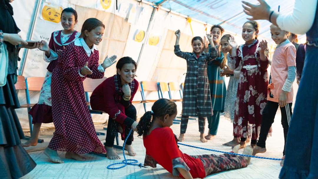 Several girls playing with a rope