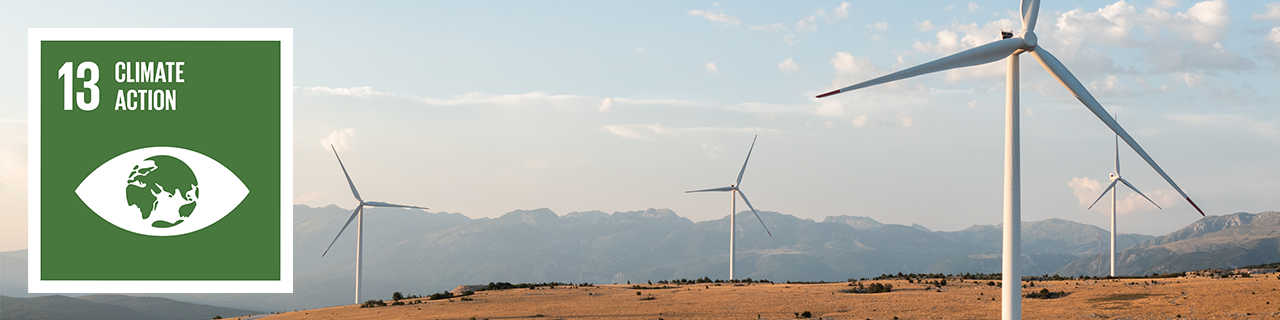 Wind wheels on a hill, next to it the icon of SDG 13: Climate Action