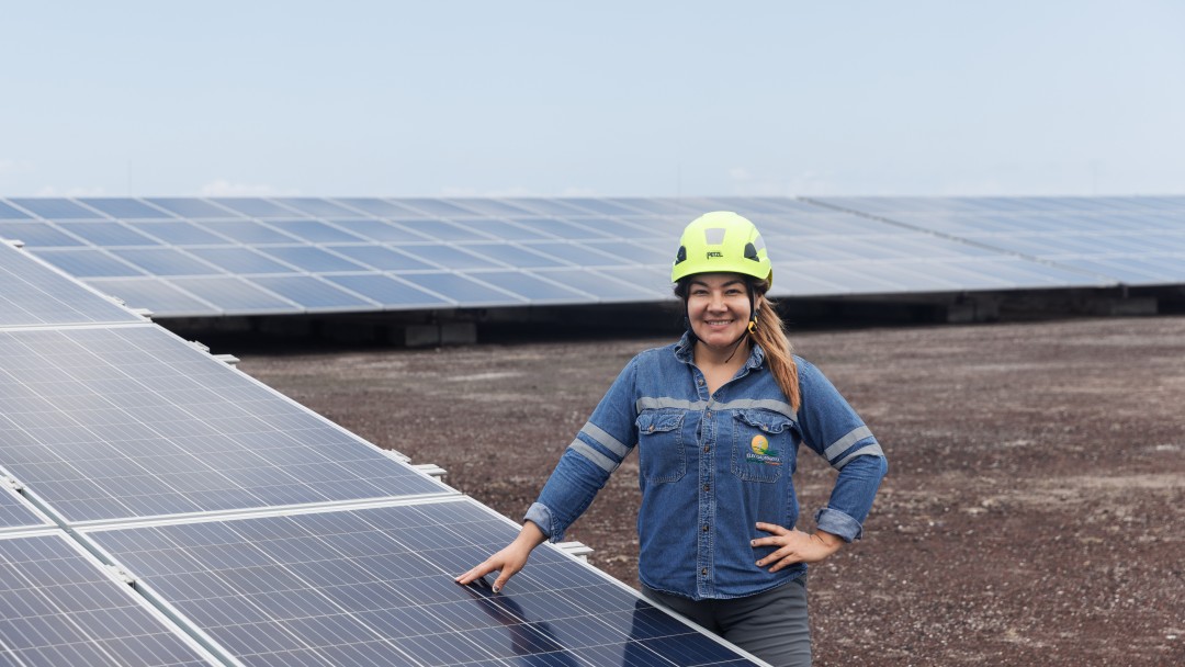 Worker in front of solar panels