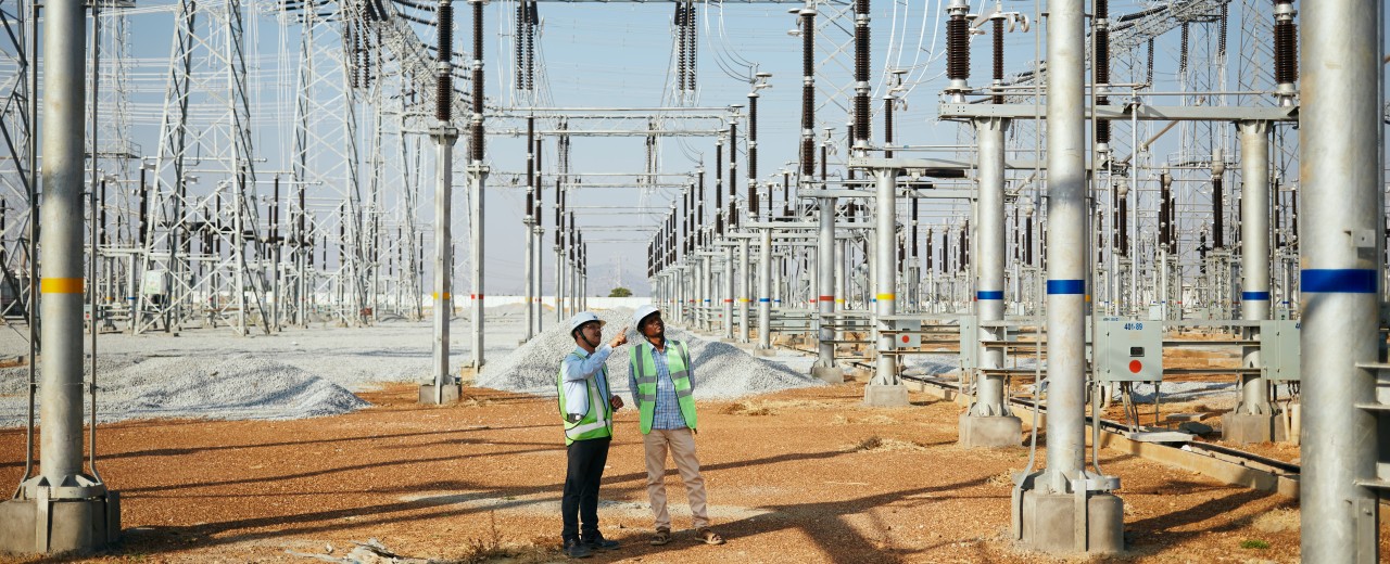 Two employees at a substation