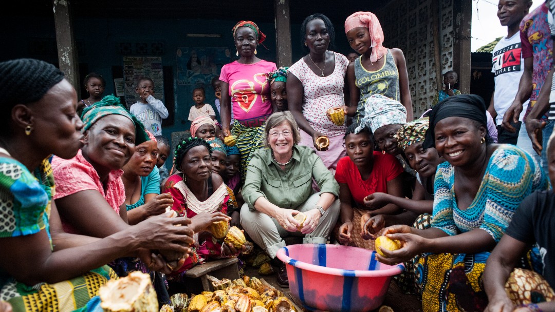 Women opening cocoa fruits