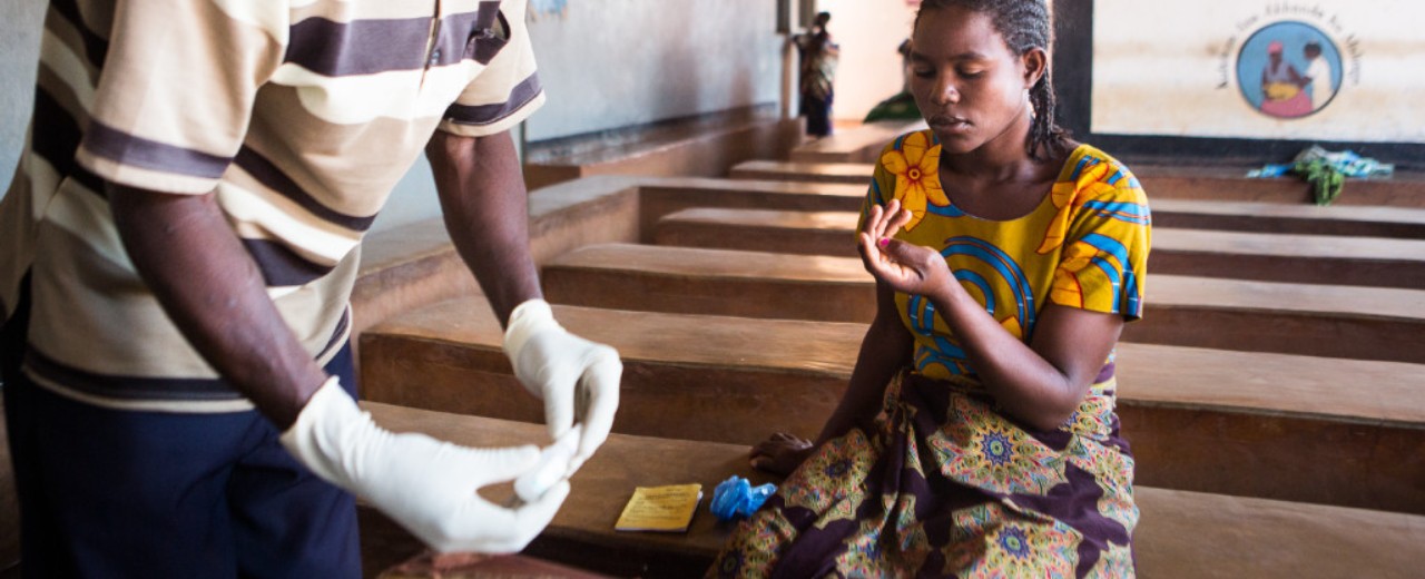 Woman taking a malaria rapid test