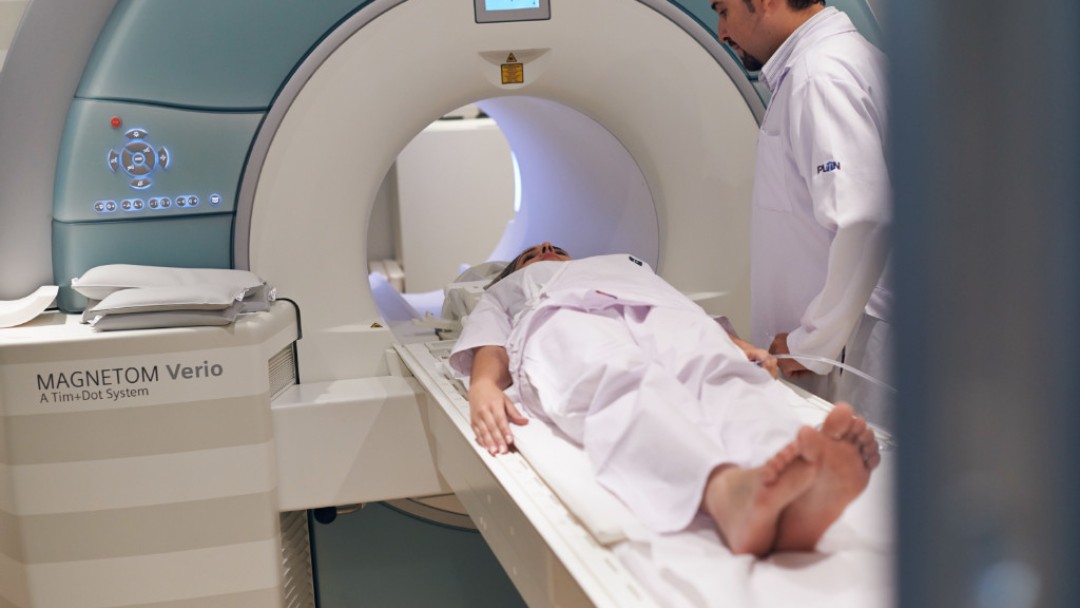 Woman on a couch in the computer tomograph