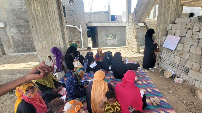 Several women are taught together by one teacher