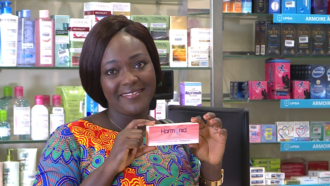 A young Ivorian woman buys contraceptives at a pharmacy 