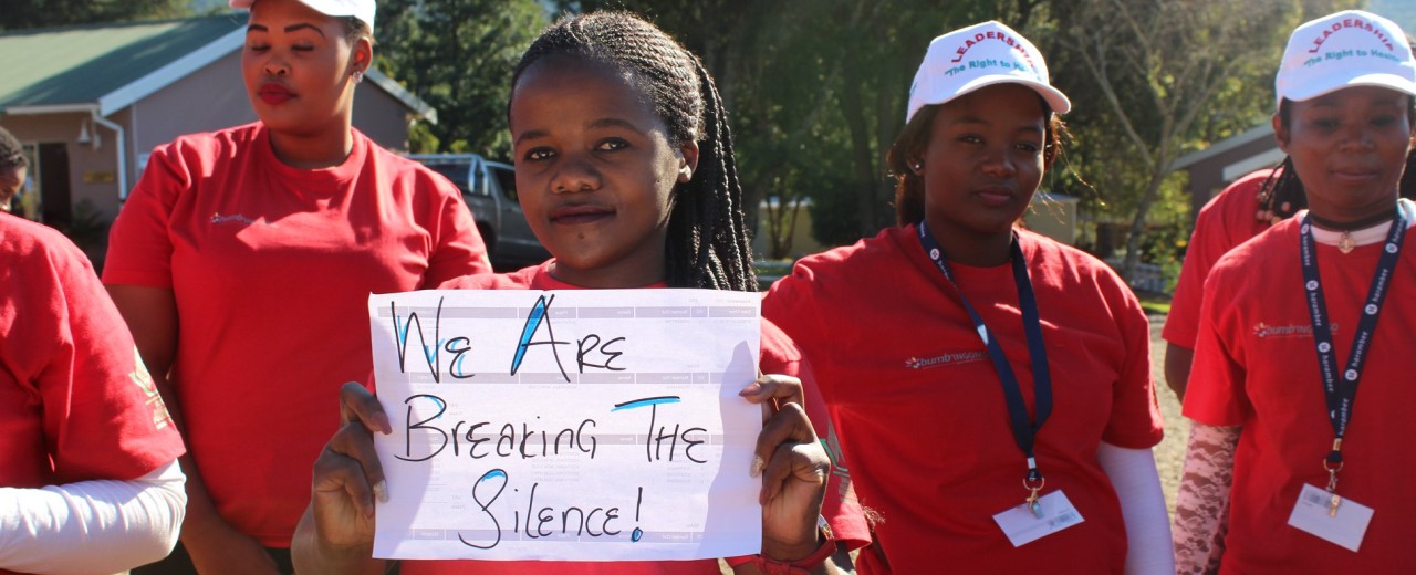 Young Women with a sign: "We are breaking the silence!"