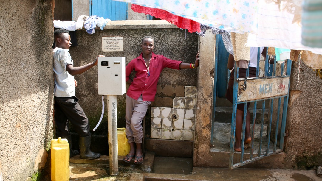 two men are lined up to fetch water