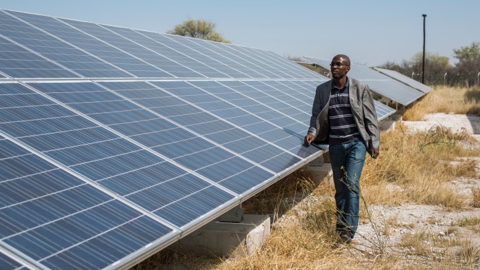 Man in front of solar panels