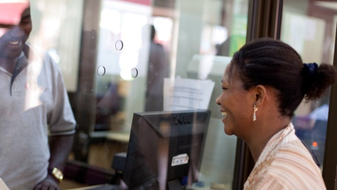 Employee and customer at a Bank counter during the granting of a microcredit