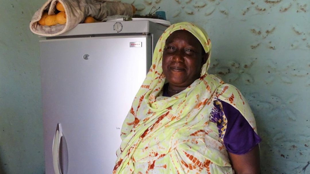 Woman next to a refrigerator