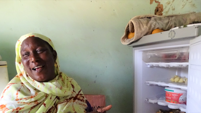 Woman next to opened refrigerator