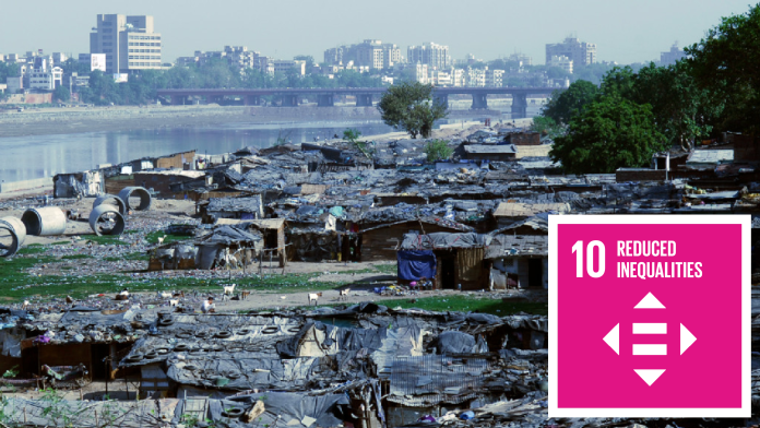 Slums, in the background skyscrapers, next to SDG 10 Icon: Reduced inequalities 