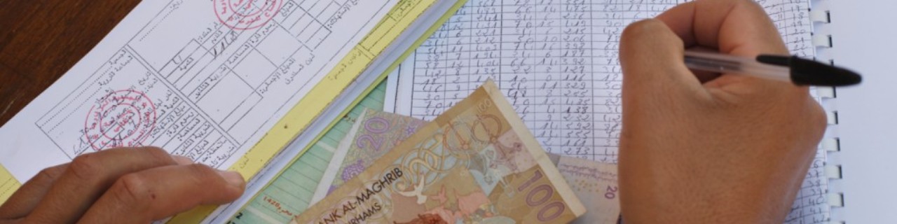 A men writing, money on the table.