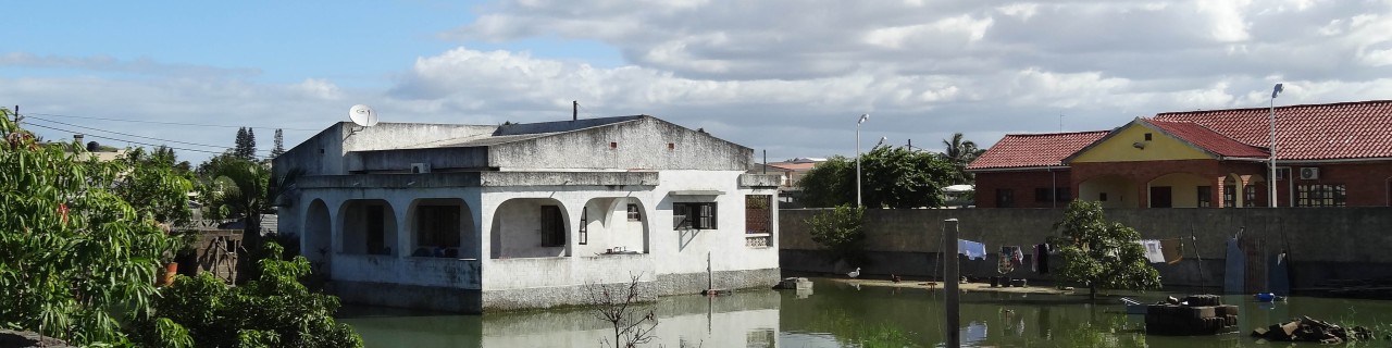 Two houses surrounded by floods