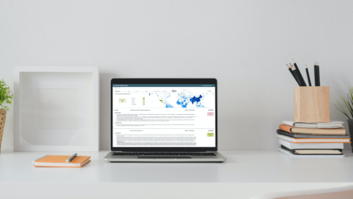 The screen on the notebook shows an open side of a web-based application