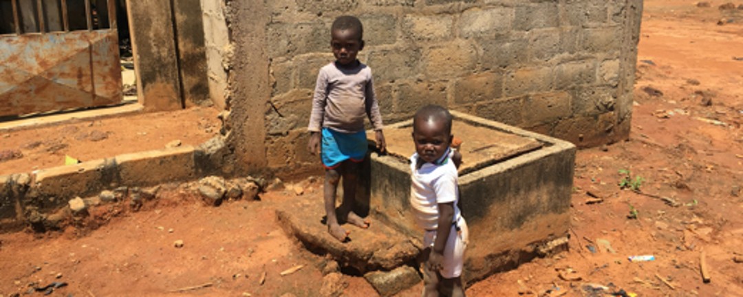 Two small children in front of a building