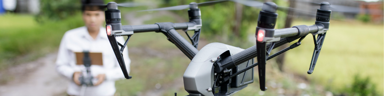 Man controlling a drone. Drone is in the foreground.