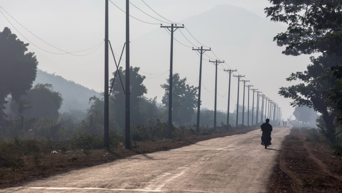 Single Motorcycle on the unpaved Road to Kinda Dam, Myanmar